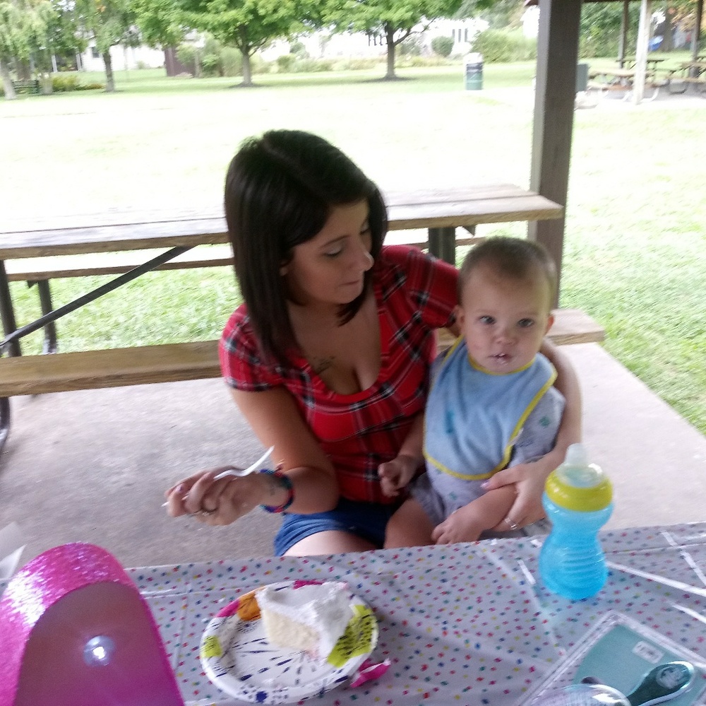 A mirror with wood frame and rosed